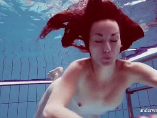 Skinny girl out in the pool cosplaying nirvana album cover underwater