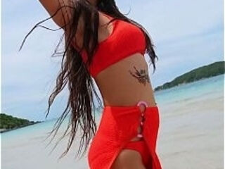 Orange bikini fun and beauty flashing on the beach
