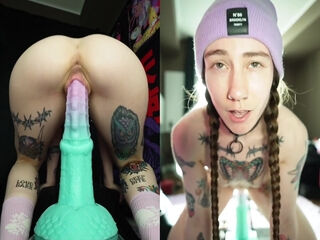 Huge standing dildo makes the inked girl riding it just ecstatic