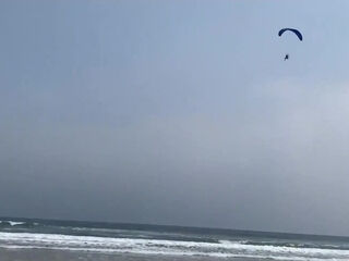 Busty MILF In Green Bikini Handjobs Her Partner On A Public Beach