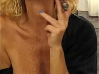 Smoking and teasing you.