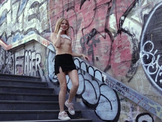 Teen blonde girl tours the city and shows off her body