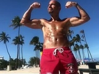 BICEP FLEXING AT THE BEACH